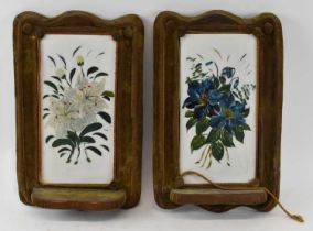 A pair of early 20th century wall mounts with porcelain hand painted plaques depicting still life of