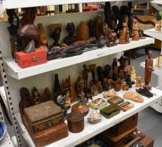 A group of Chinese and African style hardwood carvings, tins, lighters etc.