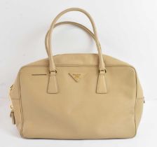 PRADA; a lady's beige leather handbag with single pocket interior, 41 x 26cm.