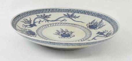 A large early 20th century Japanese Arita porcelain charger decorated with dragons to the