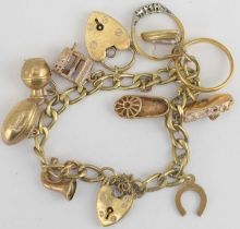 A 9ct gold charm bracelet with nine charms including horseshoe, slippers, iron, pair of rings (one