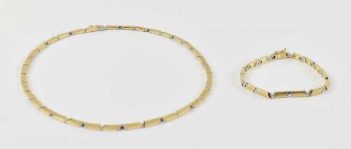 A 14ct yellow and white gold necklace with matching bracelet, approx 48g, boxed with international