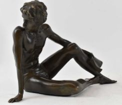 AFTER FERDINAND PREISS; a bronze figure of a reclining male with book in his left hand, height 18.