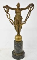 A large late 19th/early 20th century gilt bronze figure of a female standing on an orb and holding