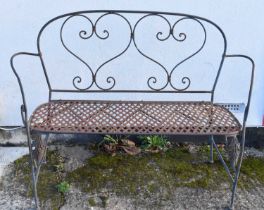 A wrought iron foldable garden bench, width 134cm.