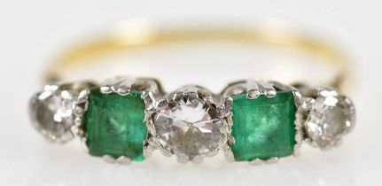 A yellow gold, emerald and diamond five stone ring formed of twin square cut emeralds and three