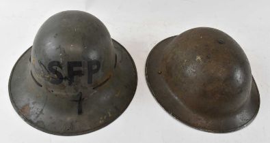 Two military helmets, one green painted and inscribed 'SFP', inside head diameter 18.5cm, the