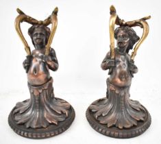 A pair of late 19th/early 20th century cast metal figures of cherubs, height 28cm.