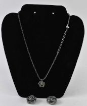 CHRISTIAN DIOR; a white metal necklace suspending pendant set with small white stones, together with