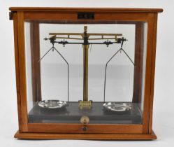 GRIFFIN & TATLOCK; a pair of scientific scales in glazed case, width 45cm.