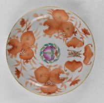 A Republic period Chinese porcelain dish painted in iron red with the sanduo around a Famille Rose