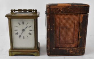 A late 19th/early 20th century brass cased carriage clock, height 11cm, complete with leather