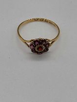 A 22ct yellow gold dress ring with flower head garnet setting, size R, approx. 2g.