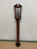 COMITTI OF LONDON; a reproduction mahogany and chevron strung stick barometer with silvered dial,