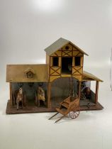 A German stable, open at ground level with half timbered hayloft above the central section and a