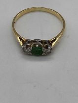 An 18ct yellow gold pale emerald and diamond three stone ring, size N, approx. 2.1g.