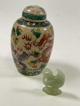 A Chinese crackle glaze ovoid jar and cover painted with five claw dragons and bearing painted
