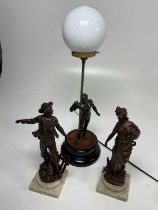 A pair of bronze style figurines and a figural table lamp of Hercules, height of lamp 60cm