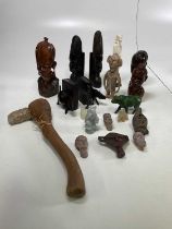 A collection of carved African wooden figures, pottery heads, carved soapstone figures, etc.