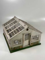 ATTRIBUTED TO LINES; an unusual Art Deco period greenhouse with original staging and many