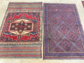 A handmade Mushwani rug also with a a small Persian blue red and cream rug. 85 cm x 140cm.