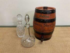 A Cadoza sherry barrel, height 34cm, with two decanters (3)