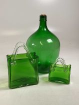 Decorative green glass, comprising a carboy and two vases in the form of handled bags.