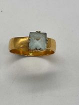 An 18ct broad yellow gold ring set with pale blue stone, size Y1/2, approx. 6.3g.