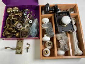 A collection of ceramic and brass door knobs and fittings