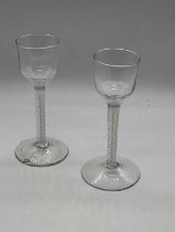 A near pair of 19th century double opaque airtwist stem cordial glasses, with ogee bowls and