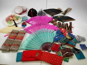 A large collection of Chinese accessories including silk purses, fans, hats, amd other items, in