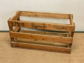 A vintage Harrods wooden crate, height 42cm, width 81cm, depth 38cm.