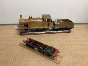 A large scratch-built copper and brass engine tender and spare frame, presented with a small section