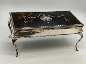 A large George V hallmarked silver and tortoiseshell mounted trinket box, the hinged rectangular lid