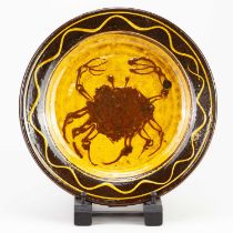 CLIVE BOWEN (born 1943); a slipware dish decorated with a crab, diameter 34.5cm, height 5cm. "Clay