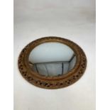 A early/mid century gilt plaster circular convex wall mirror, diameter 60cm.