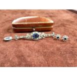 A silver paste bar brooch with central blue stone, and a pair of 9ct yellow gold sapphire and