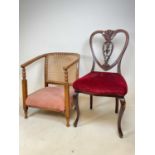 An Edwardian mahogany heart shaped backed chair, and a cane backed low tub chair (2)