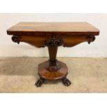 A Victorian rosewood card table with twist and fold out top to inset red baize, carved frieze to