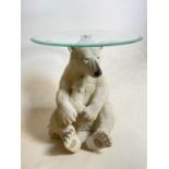 A glass topped table featuring a polar bear support