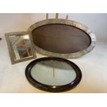 An Art Nouveau style hammered pewter oval frame and two mirrors largest 52cm h x 95cm w