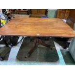 A George IV mahogany breakfast table, the rounded rectangular tilt-top raised above a ring turned