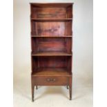 A 19th century mahogany campaign waterfall bookcase with twin side brass carrying handles, drawer to