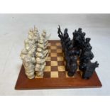 A chess set, the resin figures depicting round heads and cavaliers, tallest piece 15cmCondition