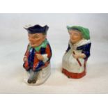 An unusual pair of late 19th century Stafforshire jugs modelled as Mr Punch and Judy, height 26cm