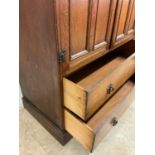 An oak tall boy, the cupboard with internal shelf with two drawers beneath, height 118cm, width