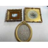 Two small gilt framed pictures, and an oval gilt framed floral embroidery (3).