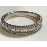 A 14ct white gold and diamond half eternity ring with central row of baguette cut stones flanked