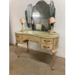 A vintage grey kidney shaped dressing table with triple mirror and attached lights, width 119cm.