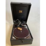 HMV; a portable gramaphone in very good condition, retaining the original card label to the inside.